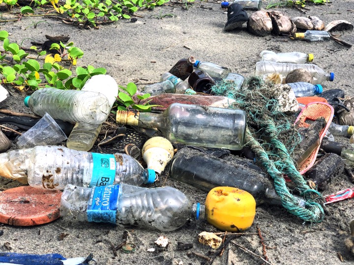 Bottles and garbage washed ashore on a beach