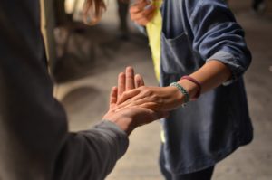 Person with outstretched hand helping another person