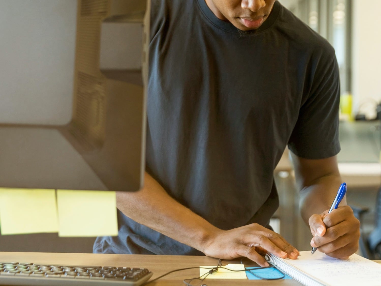 Student taking notes and writing