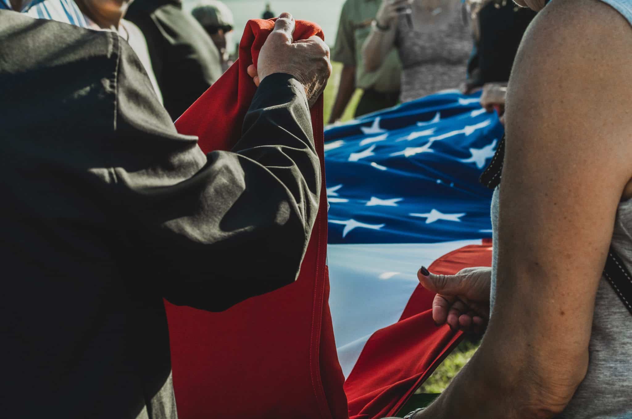 People lowering the American flag at Fort Sumter in Charleston, South Carolina