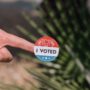 Woman holding an I Voted sticker