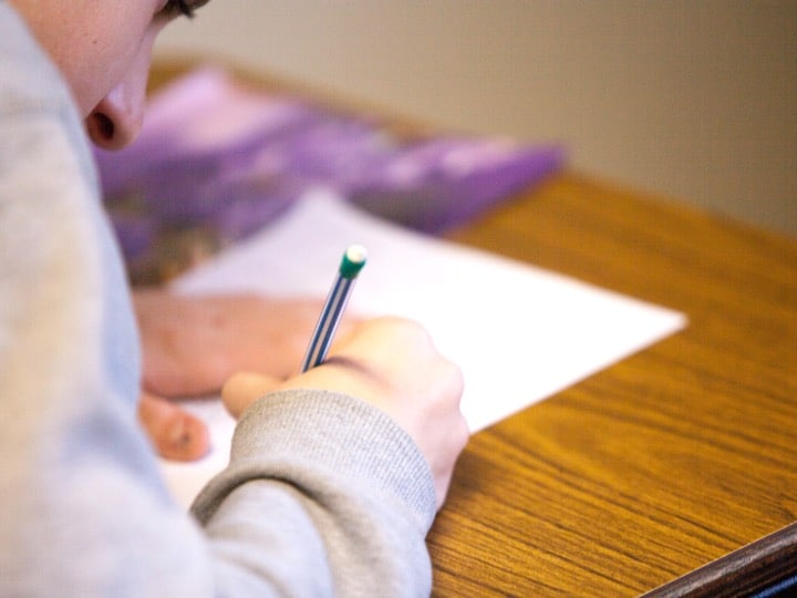 Student taking notes and writing